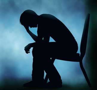 Silhouette of a young person sitting in a chair looking troubled