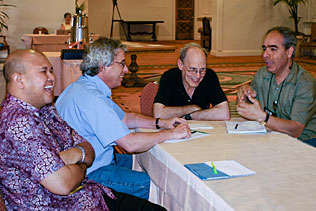 Adhi Nurhidayat, Indonesia; Dave Metzger, University of Pennsylvania; Sam Friedman, NDRI and Bijan Nassirimanesh, Canada sitting at a table conversing with each other.