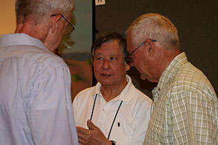 Carl Leukefeld, University of Kentucky; Walter Ling, UCLA; Clyde McCoy, University of Miami standing and talking to each other.