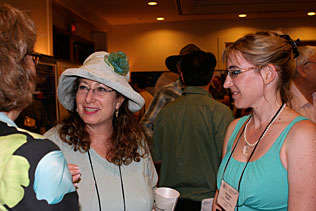Wendee Wechsberg, RTI International and Bronwyn Myers, South Africa standing and talking to another woman.