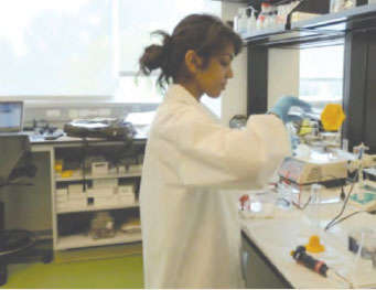 High school student Geetika Baghel is pictured working at a laboratory bench