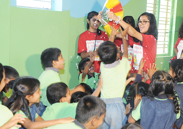 Honorable mention Nikhiya Shamsher performing magic tricks at a Bags, Books and Blessings event.