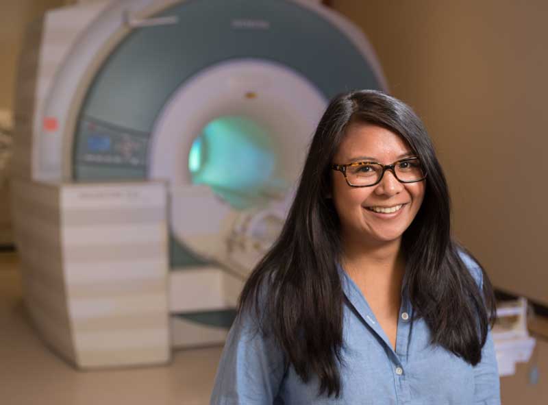 Nina Lauharatanahirun in front of the MRI machine at Virginia Tech